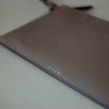 Front view of the Wristlet Leather Pouch in Grey Pebbled Leather by Enso Design Lab™, designed by Ani Han.