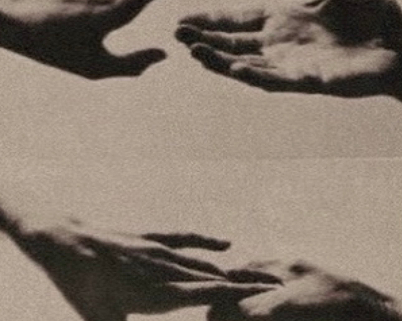 Hands shaping sculptural form in black and white, illustrating essentialism in design