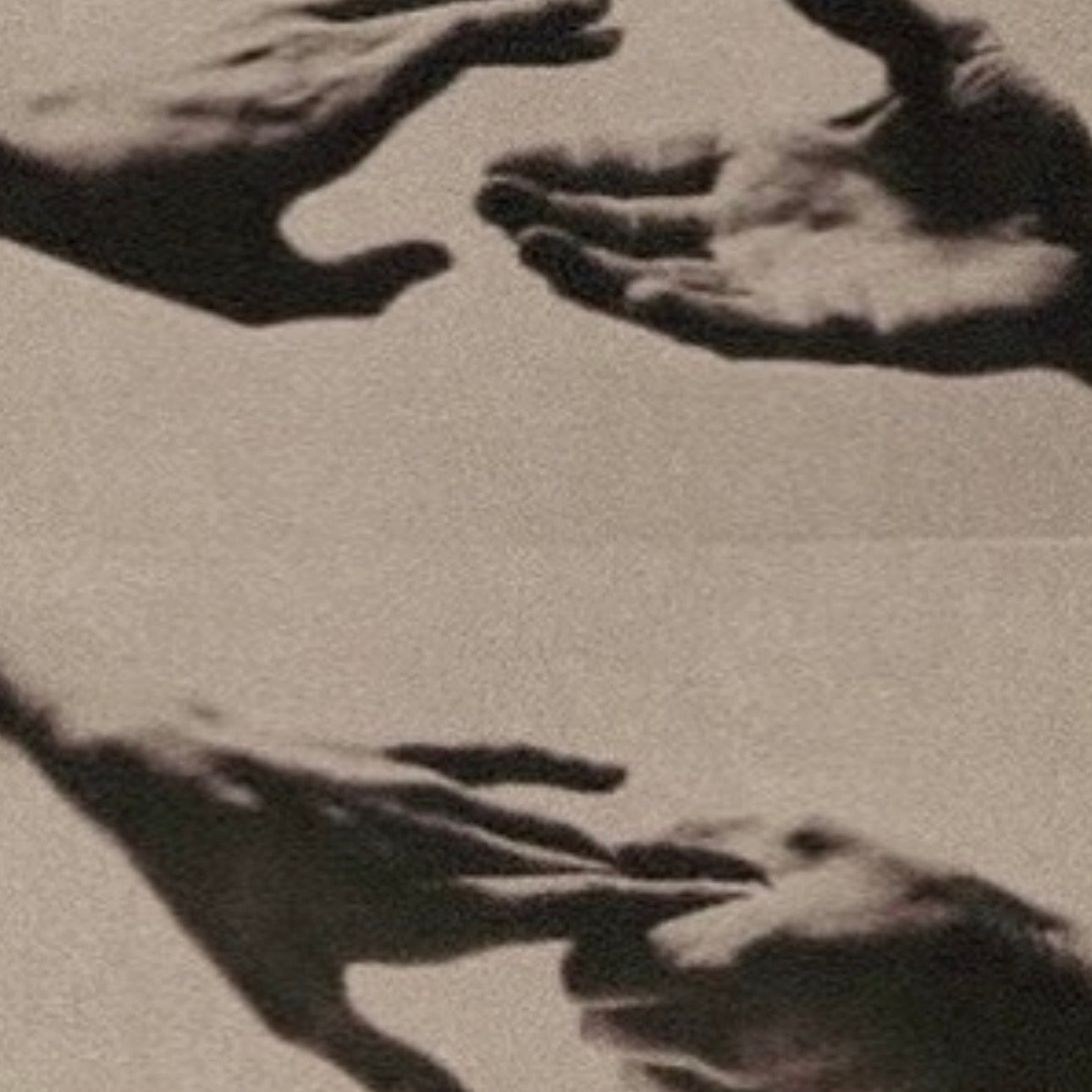 Hands shaping sculptural form in black and white, illustrating essentialism in design