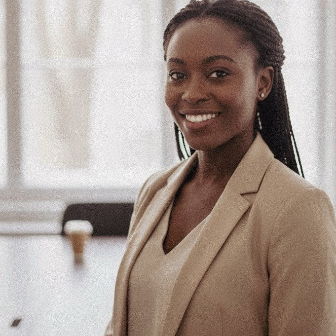 Woman wearing a beige blazer in an indoor setting
