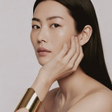 Model wearing Shell Cuff gold-plated brass bracelet on wrist