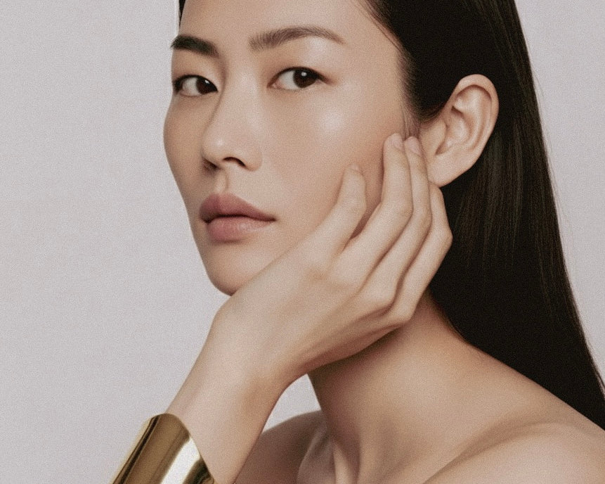 Model wearing Shell Cuff gold-plated brass bracelet on wrist