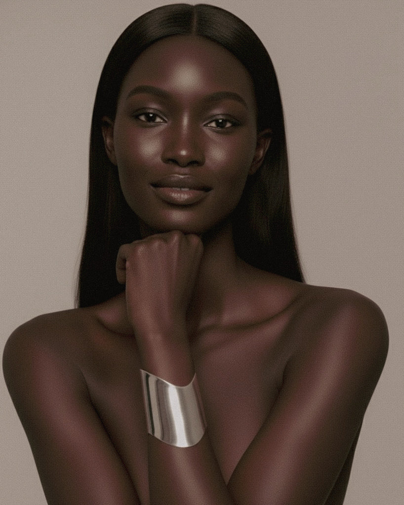 Model with long, straight hair wearing a silver Shell Cuff on a beige background.